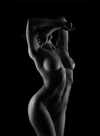 soft covered-face pose highlighting her improved look after breast augmentation treatment in chicago